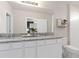 Modern bathroom showcasing double sinks, granite countertop, and tiled walk-in shower at 3626 Cambridge Brook Dr, Davenport, FL 33837