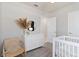 Bright Bedroom featuring a white dresser, round mirror, and soft gray carpet, creating a serene space at 3626 Cambridge Brook Dr, Davenport, FL 33837