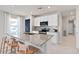 Well-lit kitchen with stainless steel appliances, bar seating, and white cabinetry at 3626 Cambridge Brook Dr, Davenport, FL 33837