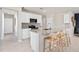Bright kitchen featuring white cabinets, granite countertops, stainless appliances and a breakfast bar at 3626 Cambridge Brook Dr, Davenport, FL 33837
