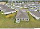 Aerial view of home with fenced backyard and patio in residential community at 425 Singing Sands Cir, Lake Wales, FL 33859