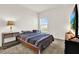 This bedroom offers a cozy bed, a window, and a simple nightstand at 425 Singing Sands Cir, Lake Wales, FL 33859
