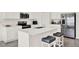 Bright kitchen featuring white cabinetry, stainless steel appliances, and a large center island at 425 Singing Sands Cir, Lake Wales, FL 33859