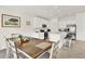 Bright kitchen featuring white cabinets, stainless steel appliances, and an adjacent dining area at 425 Singing Sands Cir, Lake Wales, FL 33859