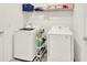 This laundry room is equipped with a washer and dryer, and wire shelving at 425 Singing Sands Cir, Lake Wales, FL 33859