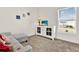 This living room features a grey sofa and white cabinet with a TV on top at 425 Singing Sands Cir, Lake Wales, FL 33859