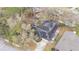 Aerial of the home featuring a screened-in pool, solar panels, and a backyard play area at 432 Wilderness Dr, Longwood, FL 32779
