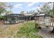 Expansive backyard featuring a screened pool, playground, solar panels, and patio at 432 Wilderness Dr, Longwood, FL 32779