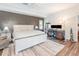 Comfortable bedroom with neutral colors, an accent wall, and wood-look flooring at 432 Wilderness Dr, Longwood, FL 32779