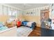 Charming bedroom with blue accents, painted stripes, and warm wooden flooring at 432 Wilderness Dr, Longwood, FL 32779