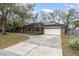 Charming brick home featuring a two-car garage, solar panels, and a well-maintained front yard at 432 Wilderness Dr, Longwood, FL 32779