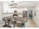 Stylish kitchen featuring white cabinets, stainless steel appliances, and a breakfast bar at 432 Wilderness Dr, Longwood, FL 32779
