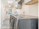 Convenient laundry room featuring modern washer and dryer units and ample storage at 432 Wilderness Dr, Longwood, FL 32779