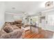 A cozy living room with hardwood floors, a comfortable couch, and decorative shelving at 432 Wilderness Dr, Longwood, FL 32779