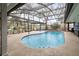 Backyard view of a refreshing pool with a screened enclosure and surrounding greenery at 432 Wilderness Dr, Longwood, FL 32779