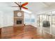 Sun room featuring hardwood floors, a skylight, and a brick fireplace at 432 Wilderness Dr, Longwood, FL 32779