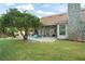 Expansive backyard showcasing a pool with rock features and well-maintained landscaping at 5138 Fairway Oaks Dr, Windermere, FL 34786