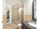 Bathroom featuring a glass shower, granite countertop vanity, and exterior access at 5138 Fairway Oaks Dr, Windermere, FL 34786