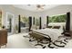 Well-lit bedroom featuring backyard views from multiple windows, decorative furniture, and neutral colors at 5138 Fairway Oaks Dr, Windermere, FL 34786