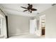Bright bedroom featuring a ceiling fan and view to ensuite bathroom at 5138 Fairway Oaks Dr, Windermere, FL 34786