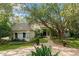 Charming single-story home featuring lush landscaping and a welcoming brick pathway, enhancing its curb appeal at 5138 Fairway Oaks Dr, Windermere, FL 34786