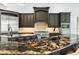Open-concept kitchen with a fireplace, a breakfast bar and bright windows at 5138 Fairway Oaks Dr, Windermere, FL 34786