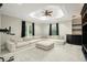 Comfortable living room with a large sectional sofa, a ceiling fan, and a custom built-in media center at 5138 Fairway Oaks Dr, Windermere, FL 34786