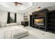 Comfortable living room with a large sectional sofa, a ceiling fan, and a custom built-in media center at 5138 Fairway Oaks Dr, Windermere, FL 34786