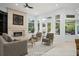 Bright living room with fireplace, neutral furniture, and views of the pool at 5138 Fairway Oaks Dr, Windermere, FL 34786