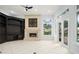 Bright living room featuring a decorative fireplace, a large window and a custom built-in media center at 5138 Fairway Oaks Dr, Windermere, FL 34786