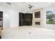 Bright living room featuring a decorative fireplace, a large window and a custom built-in media center at 5138 Fairway Oaks Dr, Windermere, FL 34786