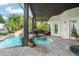 Resort-style pool area featuring rock waterfall, lush greenery, and a relaxing seating area at 5138 Fairway Oaks Dr, Windermere, FL 34786