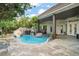Backyard pool with a rock waterfall and slide; the perfect place to enjoy sunny days at 5138 Fairway Oaks Dr, Windermere, FL 34786
