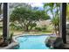 Inviting pool view showcases lush landscaping and serene outdoor living at 5138 Fairway Oaks Dr, Windermere, FL 34786