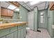 Unique green bathroom with wood vanity, mirror, and shower, a distinctive and functional design at 525 S Crystal Lake Dr, Orlando, FL 32803