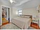 Cozy bedroom with a large bed, wood floors, and an adjacent closet with ample storage at 525 S Crystal Lake Dr, Orlando, FL 32803