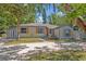Charming single-story home featuring gray siding, yellow shutters, and a well-maintained front yard with mature trees at 525 S Crystal Lake Dr, Orlando, FL 32803
