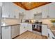 Modern kitchen featuring white cabinets, stainless steel appliances, and beautiful backsplash at 525 S Crystal Lake Dr, Orlando, FL 32803