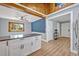 Open kitchen featuring white cabinets, a breakfast bar, stainless steel appliances and vaulted ceilings at 525 S Crystal Lake Dr, Orlando, FL 32803