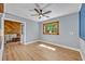 Comfortable living room with wood floors, light gray walls, and a window with natural lighting at 525 S Crystal Lake Dr, Orlando, FL 32803