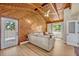 Comfortable living room with vaulted wood ceiling, light colored walls, wood floors and natural light at 525 S Crystal Lake Dr, Orlando, FL 32803