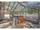 Outdoor kitchen with seating, barstools, grill and steel roof overhead for cooking outside at 525 S Crystal Lake Dr, Orlando, FL 32803