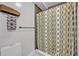Tiled shower featuring neutral-patterned curtains, a mounted rack, and sleek design at 525 S Crystal Lake Dr, Orlando, FL 32803