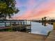 Beautiful sunset over the water with a pier extending over the water and the city skyline in the background at 525 S Crystal Lake Dr, Orlando, FL 32803