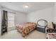 Cozy bedroom features a large window for natural light and a comfortable bed with a colorful quilt at 615 Blue Park Rd, Orange City, FL 32763