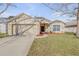 Charming single-story home featuring a two-car garage and a well-manicured front lawn at 615 Blue Park Rd, Orange City, FL 32763