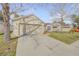 Suburban home showing a two-car garage, driveway and manicured lawn with minimal landscaping at 615 Blue Park Rd, Orange City, FL 32763
