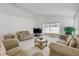 Bright living room with sliding glass doors and neutral-toned furniture at 615 Blue Park Rd, Orange City, FL 32763