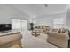 Inviting living room featuring neutral decor, plush seating, and abundant natural light at 615 Blue Park Rd, Orange City, FL 32763