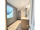 Cozy bathroom features a tiled floor, vanity, shower and window at 615 S Laurel Ave, Sanford, FL 32771